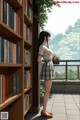 A woman standing in front of a book shelf filled with books.