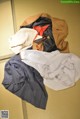 A pile of clothes sitting on top of a tatami mat.