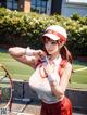 A woman holding a tennis racket on a tennis court.